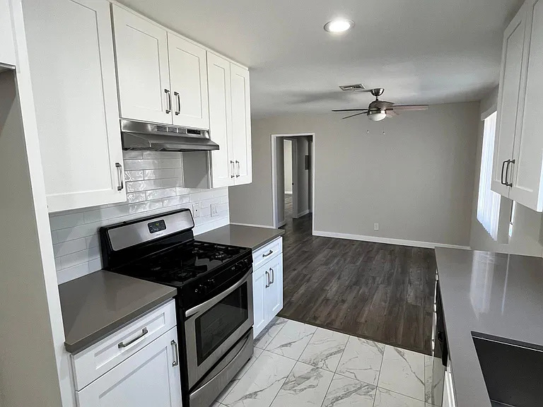 Fully renovated kitchen, with quartz countertops & stainless steel appliances
