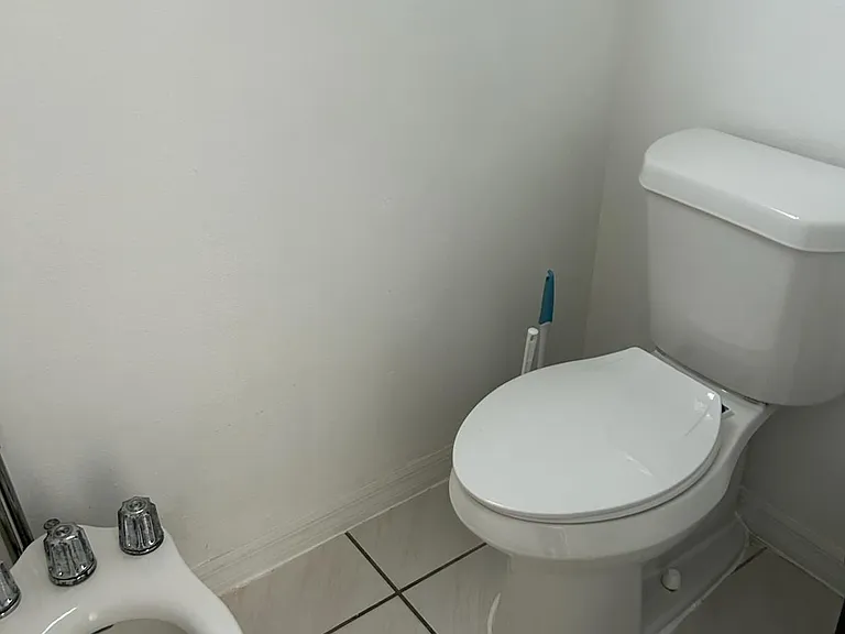 Immaculate toilet area with essential amenities for your comfort.