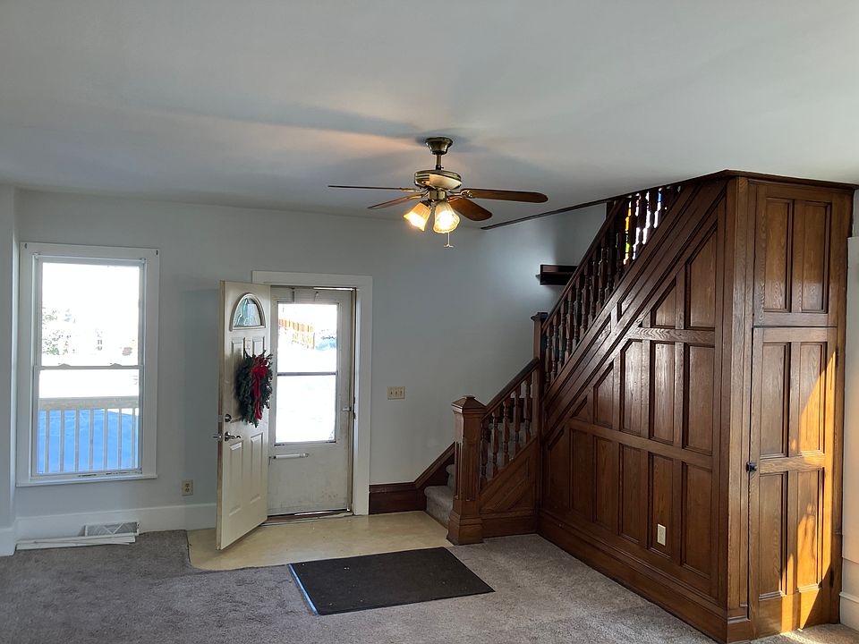 Living room is 22' x 18'. Includes set of three large windows facing east and beautiful woodwork up the stairs. Stained glass window on the landing. Under the stairs, an adorable Harry Potter under stairs closet.
