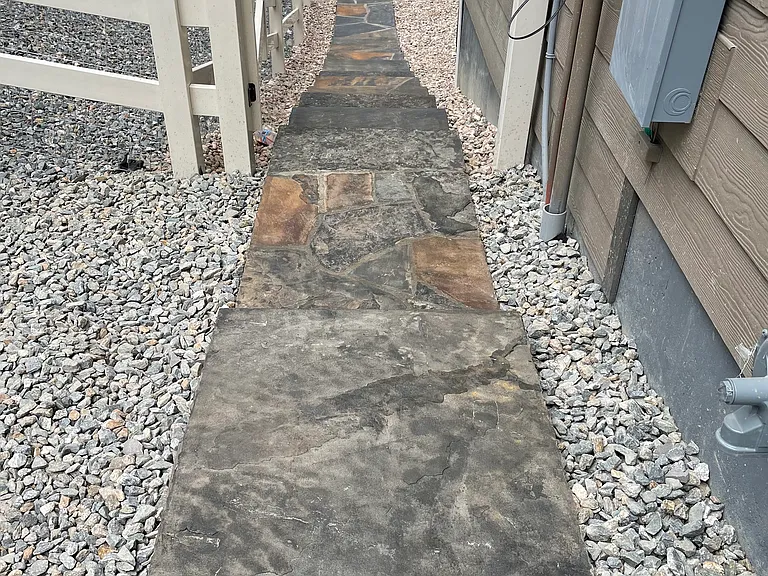 Steps from the front to the backyard on the left side of the house