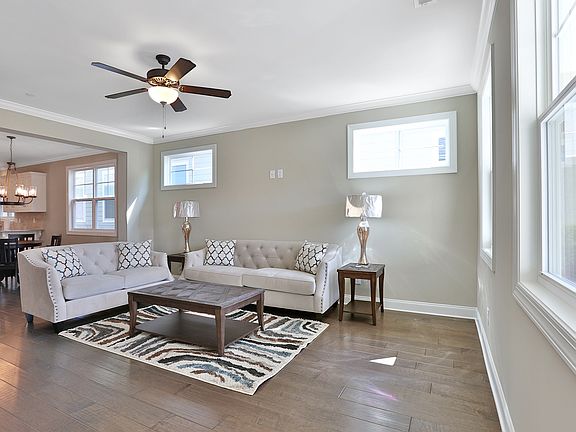 Large family living room with gorgeous floors and a view to the kitchen and dining room.