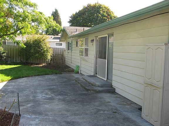 Fully fenced backyard with patio