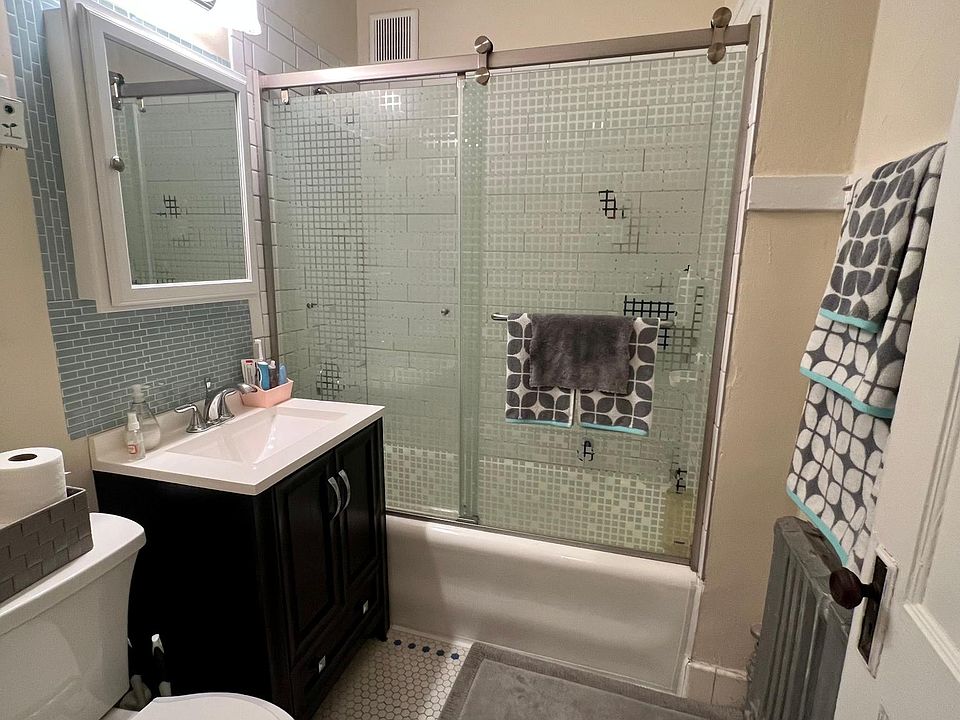Updated bathroom. New tile, vanity, shower door