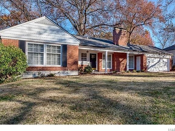 Front porch with extra access to attached garage.
