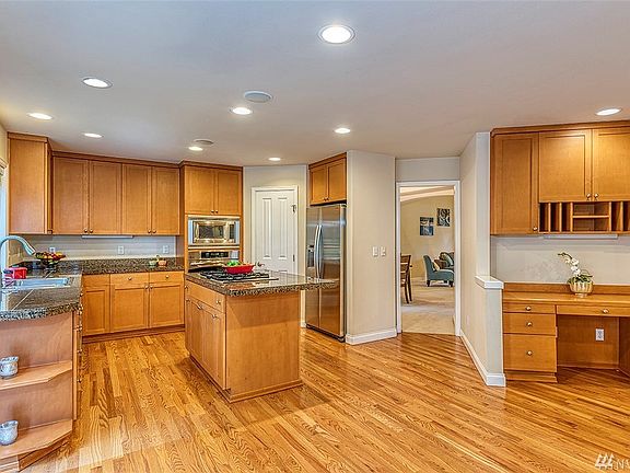 Huge kitchen with walk-in pantry and stainless steel appliances. 