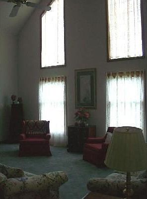 Main living room with 17 ft. vaulted ceilings and custom made insulated window