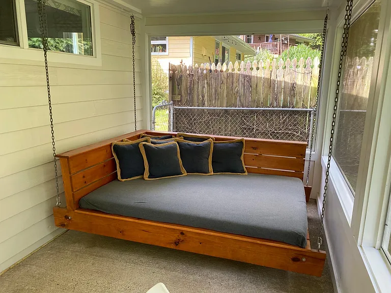 Full size bed swing in enclosed porch