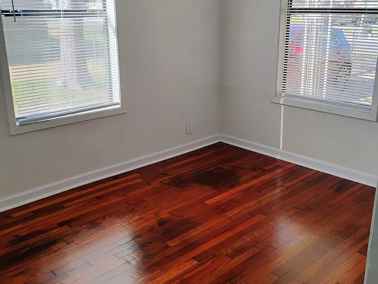 Dining room floor has been refinished to a darker color