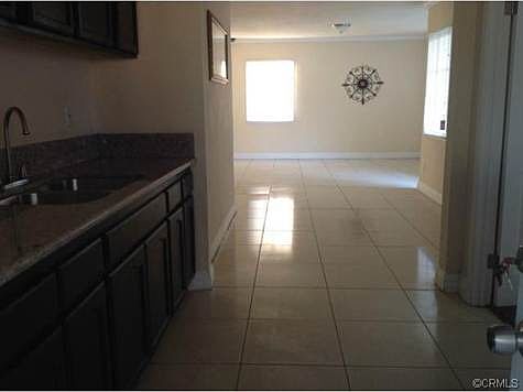 ELEGANT KITCHEN WITH GRANITE COUNTER TOPS FEATURING OPEN FLOOR P