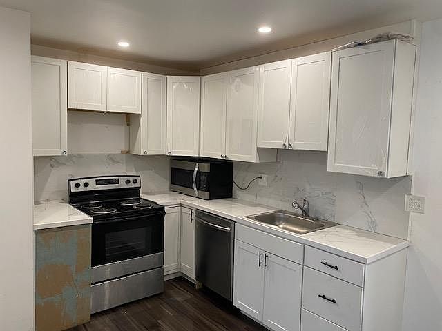 kitchen with new stove, dishwasher , microwave and sink