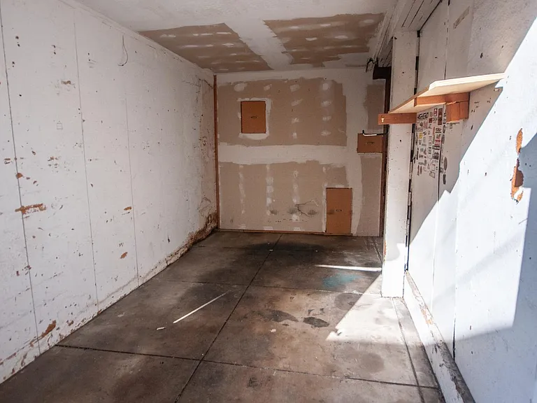 Garage fits 4-door sedan with extra storage but not bigger vehicles.