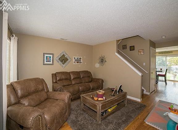 Living room includes access to upstairs, powder room, kitchen and dining area.