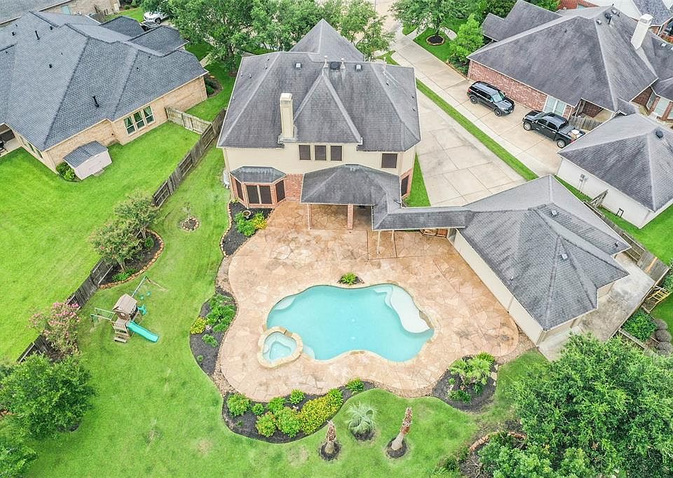 JUST LOOK at this lot! Situated in the original section of Firethorne complete with Pool and Spa, this home has surprises around every corner.