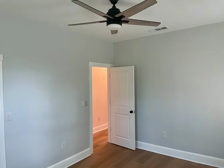 Same bedroom from inside corner view.