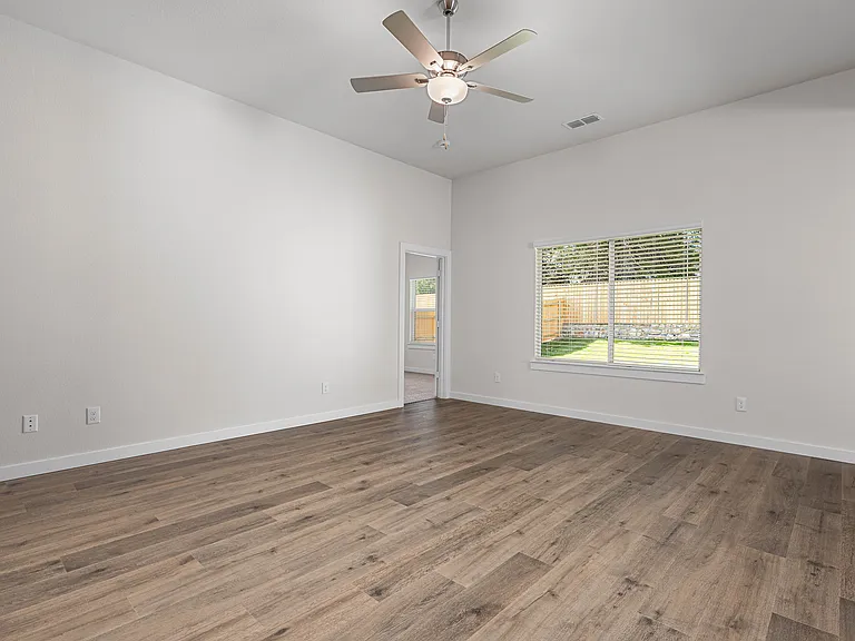 The living room has a large window that lets in great, natural light.