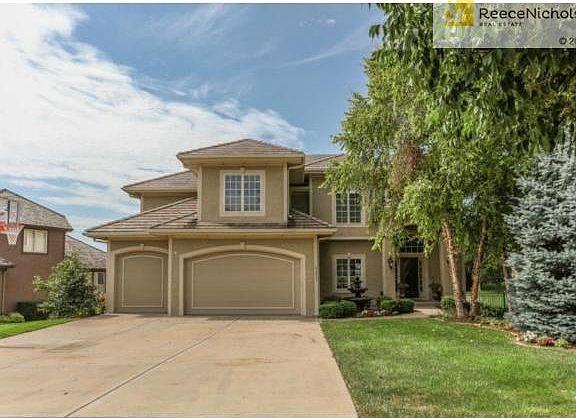 Full 3 car driveway leads to a heavily treed entrance. This fully stuccoed home has a gorgeous Spanish tiled roof.