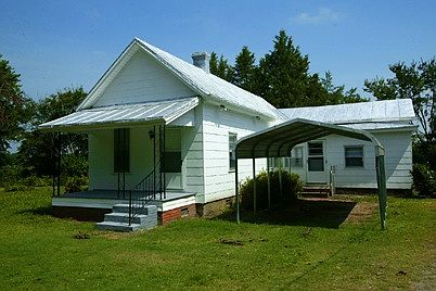 Metal carport at side entry..