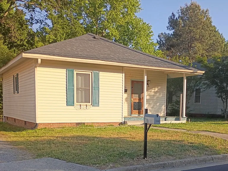 Charming single-story home with a cozy front porch, nestled in a quiet neighborhood_perfect for enjoying morning coffee or evening breezes.