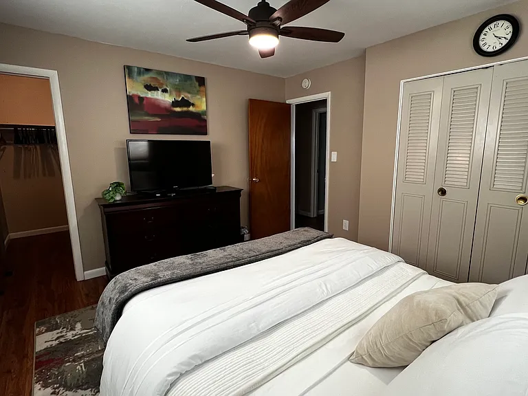 Alternate view of the primary bedroom showing generous closet space and easy access to the hall bathroom.