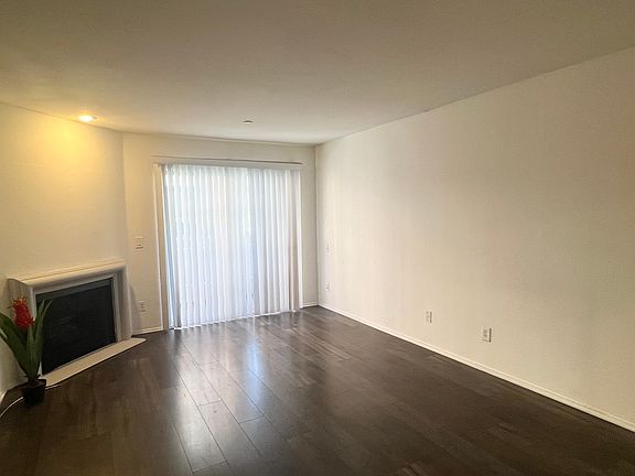 Inviting living room with a fireplace and access to the private balcony