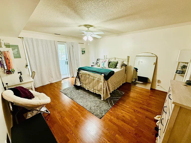 Primary bedroom. Sliding glass door leads to balcony for primary bedroom