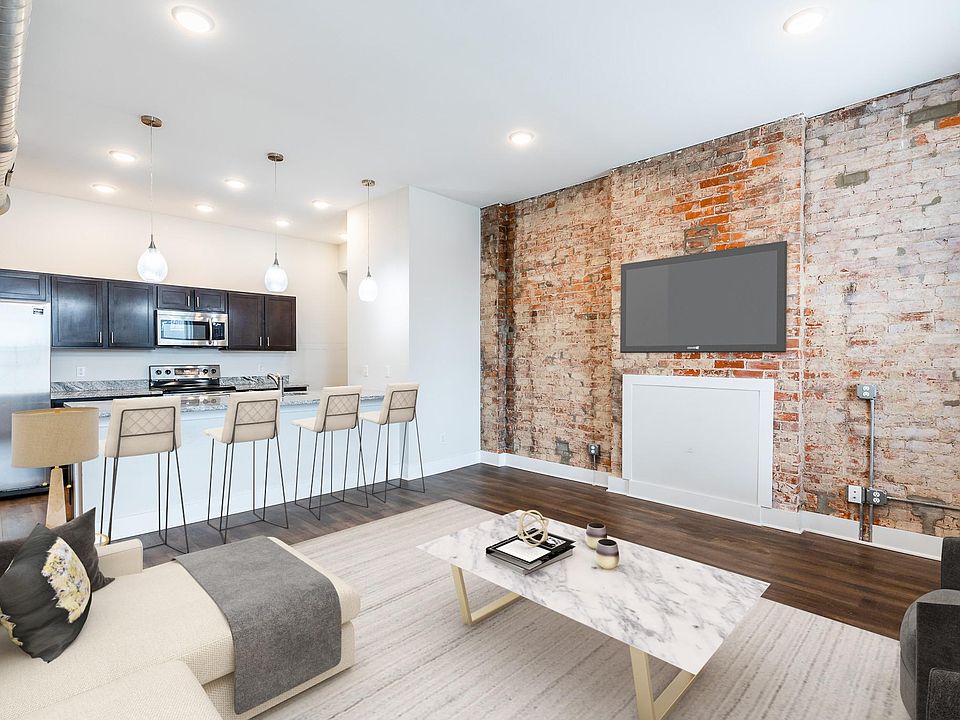 Spacious great room with exposed brick and easy care vinyl plank flooring. Move in ready.