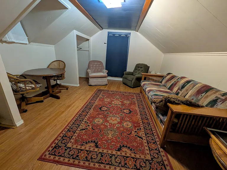 This is another set up where this room, over the downstairs bedroom, is set up as a lounge or living and dining room area - The other upstairs room is set up as the primary upstairs bedroom. Perfect for sharing the house with young adult or co-worker.