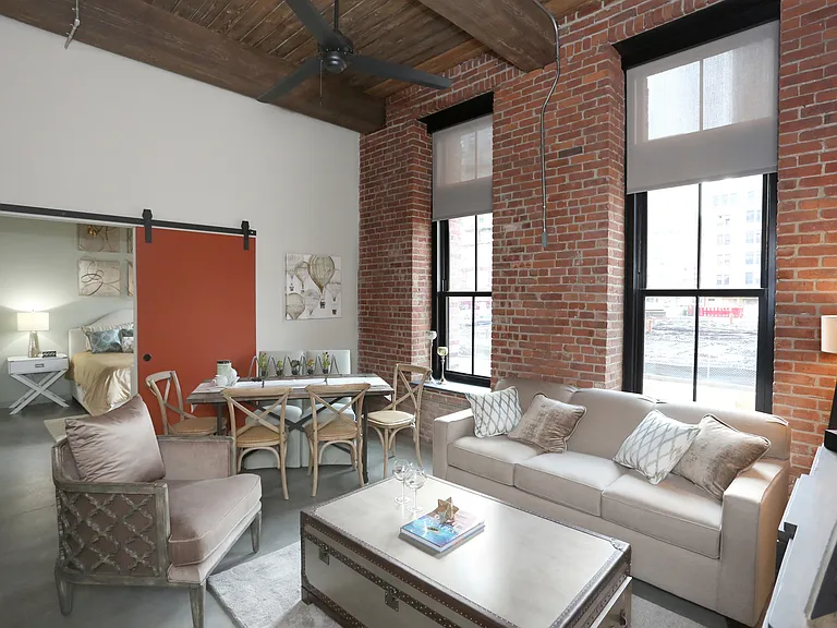 Soaring ceiling, oversized windows, and unique interior finishes