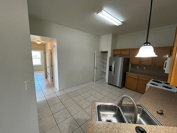 The kitchen is both functional and stylish, designed to meet all your cooking and storage needs. It features a stainless steel sink and a matching stainless steel refrigerator, giving it a clean, modern look. You'll also enjoy the convenience of an electr