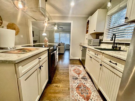Designer chef's kitchen with custom cabinetry and upgraded appliances.