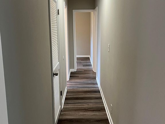 Hallway leading to laundry room (right) and bedrooms/bath