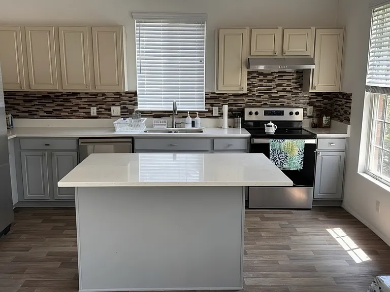 Kitchen with renovated quarts countertop and eat-in island