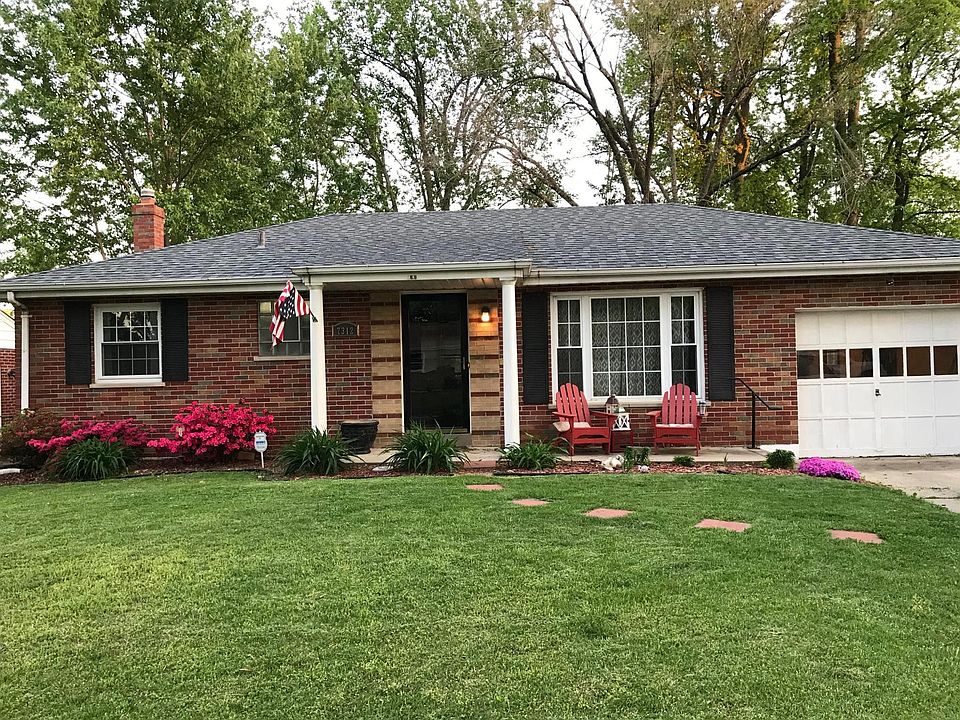 Front of House with well landscaped yard