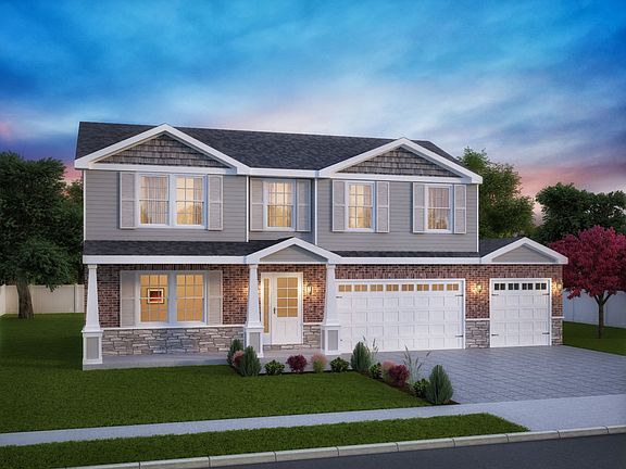 FoxGrove w brick above w 3 car, shutters and extended porch