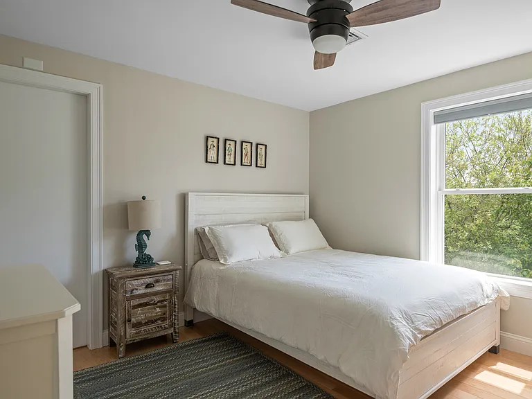 the second floor bedroom one with a full size bed