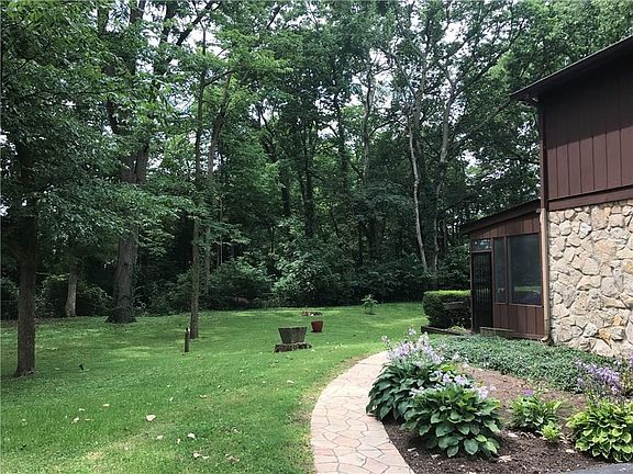 View of side yard coming off of the double car attached garage.