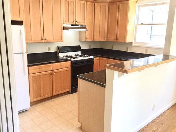 Sunny kitchen with gas range, dishwasher & disposal