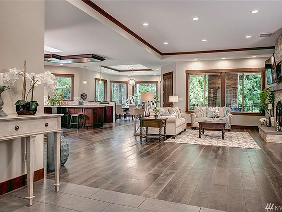 Entertaining will be a delight in this massive great room with 12 foot ceilings! To the right is french doors leading to the master suite.