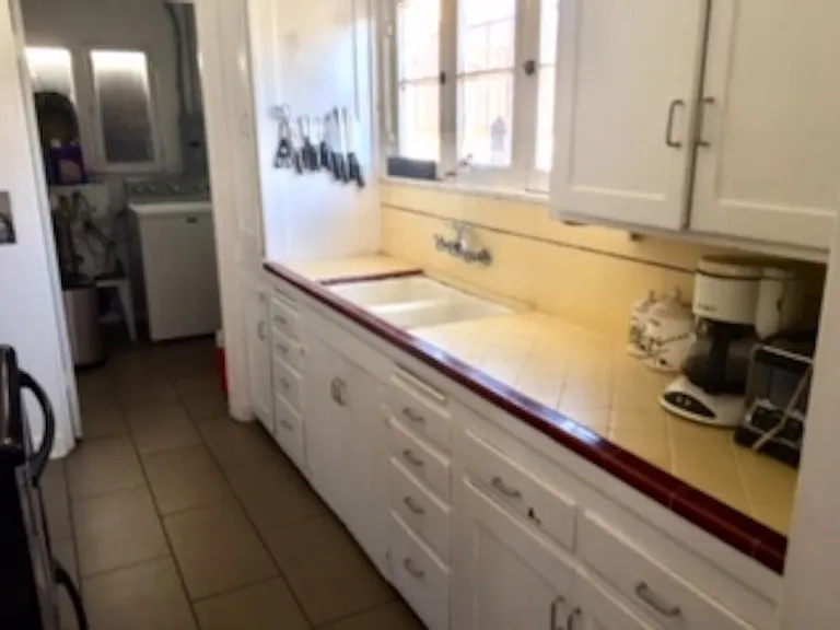 Kitchen sink, cabinets with a window facing south