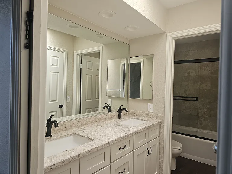 Brand new cabinetry. Double sink with quartz counters and full mirror. Skylight in this room as well.