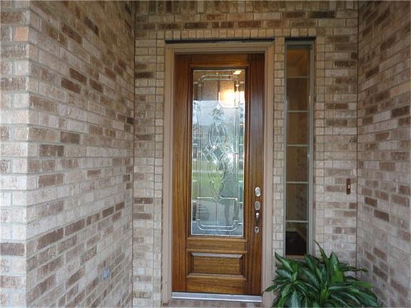 Landscaping with moss rock, front porch with slate tile and a leaded front door greet you as you ent