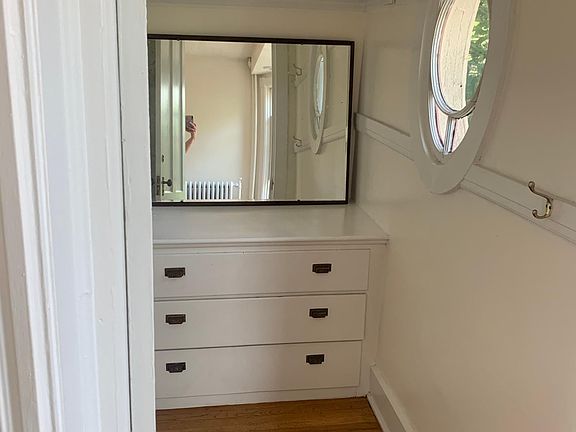 Closet off bedroom with original hardware and built in drawers