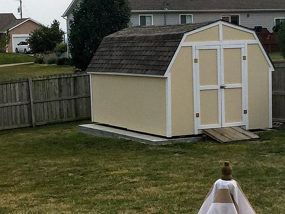 Spacious shed on concrete.