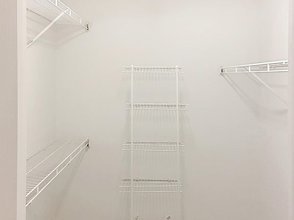 Large walk in closet with shelving