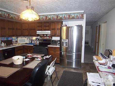Nice eat in kitchen with stainless steel fridge and stove
