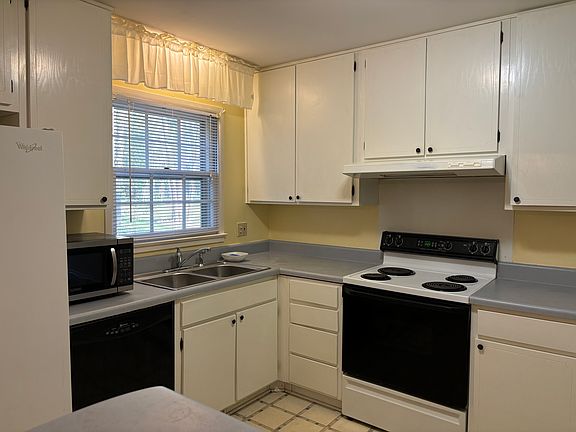 Kitchen with refrigerator, dishwasher, stove, microwave, and plenty of cabinet space.