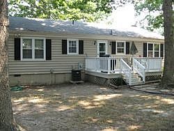 Back of house with freshly painted large deck