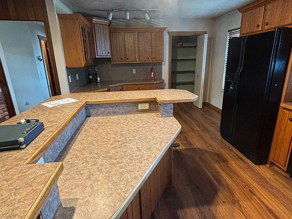 Kitchen island and built in pantry, black appliances