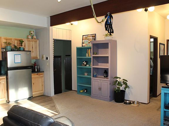 Living space with hallway and view of entryway.