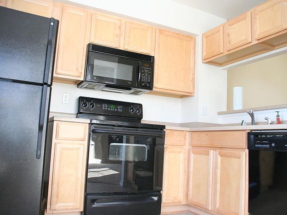 Kitchen with black appliances and nook
